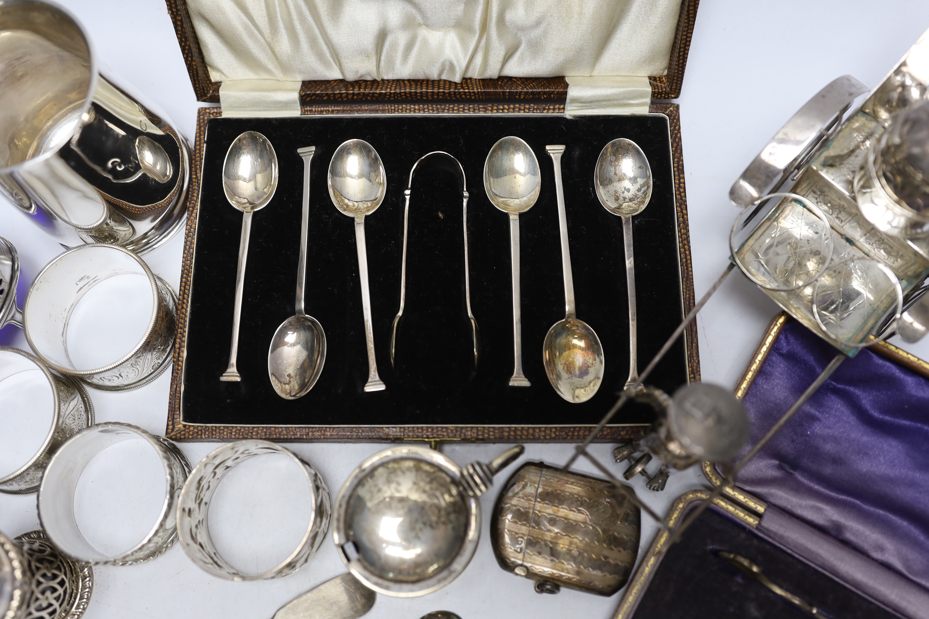 A collection of small silver to include a christening cup, a pair of late Victorian navette shaped salts, a Chinese white metal cruet (incomplete), flatware including cased teaspoons, vest case, napkin rings, etc.